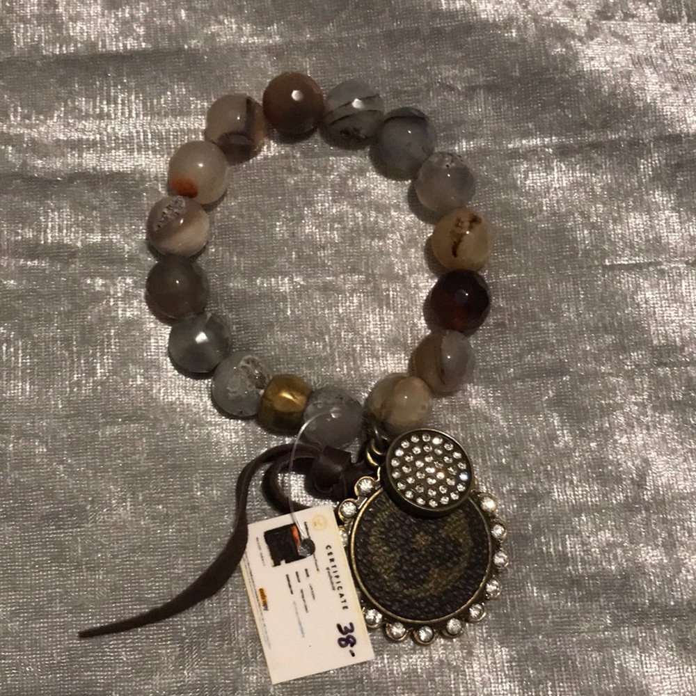 Cute never worn bracelet with charm. Still has tag on it. Warm toned
